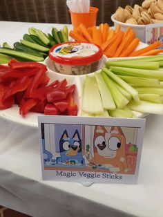 there are many vegetables on the table with some signs in front of them that say magic veggie sticks