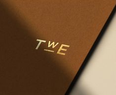 the word twe is placed on top of a brown book