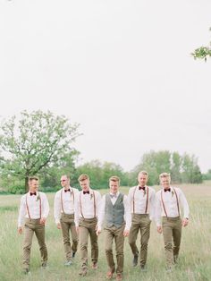 a group of men standing next to each other in a field