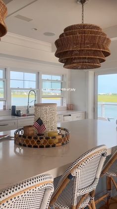 a kitchen with white counter tops and wicker chairs