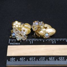 *Description: Perfect for a wedding or any formal occasion, this is a beautiful pair of vintage faux pearl crystal beaded earrings by Robert, who is believed to have been a Miriam Haskell designer. This pair of earrings have a clip on back with a small cushion plastic piece still attached. The earrings are set on a gold tone filigree base with three different designs of faux pearls and Swarovski crystal rhinestones and a gold leaf; all wired to the base giving them a great foundation for years t Beaded Wedding Earrings In Costume Jewelry Style, Vintage Bridal Earrings For Wedding, Vintage Clip-on Crystal Earrings For Wedding, Vintage Pearl Drop Clip-on Earrings For Party, Vintage Pearl Drop Clip-on Earrings, Vintage Pearl Earrings For Party, Vintage Pearl Earrings For Evening, Vintage Crystal Earrings For Wedding, Vintage Clip-on Earrings For Wedding