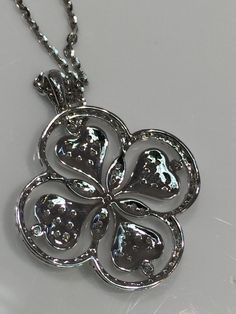 Beautiful Fancy Clover or Floral Design Diamond Pendant in 14K white gold with gem quality diamonds. Approximately F-Color, VS Clarity. Total Weight of .60 Carats of Diamonds. Lovely High Polished Back added to show attention to detail as well as style. White Gold Chain in 14 Karat Gold with Lobster Clasp included. Chain is of High Shine Cable Design. Diamond White Jewelry With Flower Shape And Diamond Accents, Diamond White Diamond Flower-shaped Jewelry, White Diamond Necklace With Flower Shape And Diamond Accents, White Diamond Necklace With Flower-shaped Accents, Diamond White Flower-shaped Diamond Jewelry, White Diamond Necklace With Flower Shape Accents, Diamond Flower Necklace For Anniversary, Diamond White Flower-shaped Jewelry With Single Cut Diamonds, Diamond White Flower-shaped Necklace With Diamond Accents