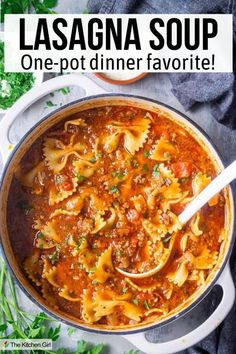 a large pot filled with pasta and sauce on top of a white table next to parsley