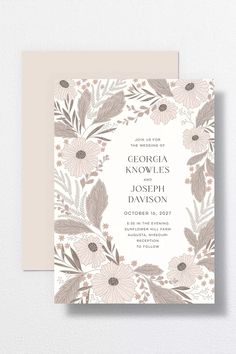 a wedding card with flowers and leaves on the front, in grey and white colors