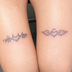 two small tattoos on both legs with hearts and wings in the shape of a heart