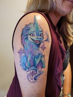 a woman with a wolf tattoo on her arm