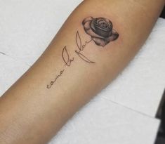 a black rose tattoo on the left arm