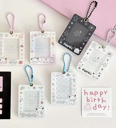 some tags are hanging on a table with other items around them and the tag says happy birthday day