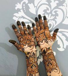 two hands that are decorated with henna