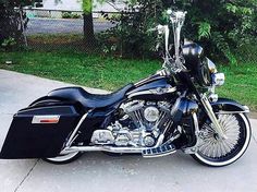 a black motorcycle is parked on the sidewalk