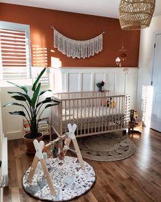 a baby crib in the middle of a room with wooden floors and white walls