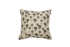 a white pillow with green flowers on it