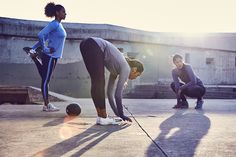 three people are playing with balls on the ground