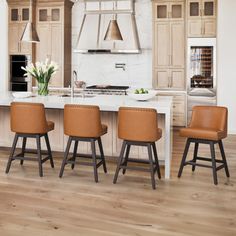 a kitchen with an island and four stools in front of the stove top oven