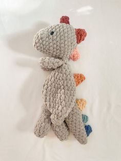 a crocheted stuffed animal laying on top of a white sheet