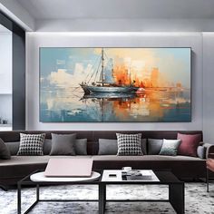 a living room filled with furniture and a large painting on the wall above it's coffee table