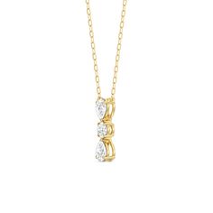 a gold necklace with three diamonds on the front and back, set in 18k yellow gold