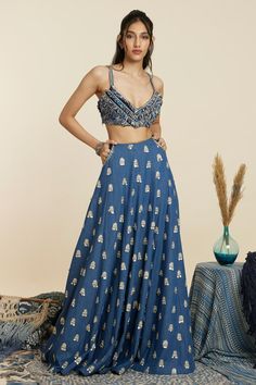 Blue denim lehenga, accentuated with all over butti embellishments in sequins. Paired with a split sleeve jacket with all over sequin embellishments. Comes along with an inner blouse with loop thread work.
Components: 3
Pattern: Embellished
Type Of Work: Sequins
Neckline: Blouse: Deep V Neck
Sleeve Type: Blouse: Sleeveless
Fabric: Denim
Color: Blue
Other Details: 
Side pockets on lehenga
Occasion: Sangeet - Aza Fashions Festive Semi-stitched V-neck Lehenga, Luxury Semi-stitched Blue Lehenga, Semi-stitched Blue Lehenga With Motifs, Blue Embroidered Sleeveless Choli, Embellished Blue Choli, Semi-stitched Embellished Blue Lehenga, Jacket Lehenga, Sequins Blouse, Embroidered Jacket