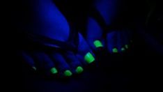 a pair of feet with green and blue lights on them