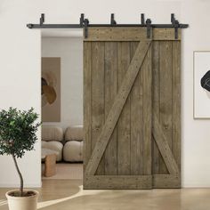 an open sliding door in a living room next to a potted plant on the floor