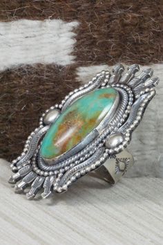 This Royston turquoise and sterling silver ring was made by Navajo silversmith Hemerson Lee. The inside of the band is signed Hemerson Brown and stamped sterling.Size: 10Length: 2 5/8"Width: 2"Free shipping on all orders! We ship with USPS and always include tracking. All orders ship within a day of payment.Returns are accepted up to 30 days after you receive your order. Just send us a message. Our shop offers cash back or store credit. The item must be returned in new condition. Southwestern Untreated Turquoise Sterling Silver Ring, Collectible Southwestern Style Silver Turquoise Ring, Southwestern Polished Turquoise Ring, Nickel-free Round Southwestern Turquoise Ring, Adjustable Southwestern Turquoise Ring Nickel-free, Royston Turquoise, Native American Jewelry, Free Jewelry, Size 10