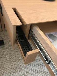 an open drawer is shown in the middle of a desk with a computer mouse on it