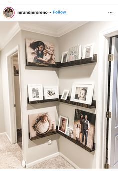 three shelves with pictures and family photos on them in the corner of a room next to an open door