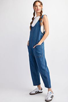 Mineral washed solid sleeveless jumpsuit featuring adjustable straps, a scoop neckline, two open front pockets and is a straight leg style. Model is 5'9" and wearing a small.75%COTTON 23%POLYESTER 2%SPANDEX Trendy Bib Front Overalls With Adjustable Straps, Trendy Overalls With Adjustable Straps And Bib Front, Medium Wash Shortalls With Adjustable Straps, Solid Denim Overalls Jumpsuit, Casual Cotton Denim Jumpsuit With Adjustable Straps, Solid Denim Overalls, Medium Wash Overalls With Adjustable Straps For Summer, Summer Medium Wash Overalls With Adjustable Straps, Summer Overalls With Adjustable Straps In Medium Wash