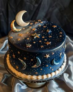 a blue cake with stars and the moon on it