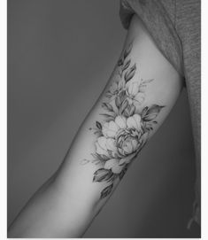 a woman's arm with flowers on it