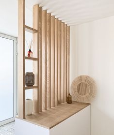 a wooden shelf sitting on top of a white wall