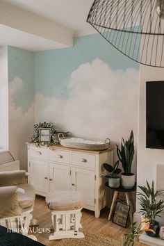 a living room with a dresser, television and potted plants