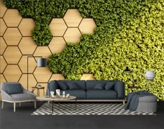 a living room with couches, chairs and a wall covered in green ivy leaves