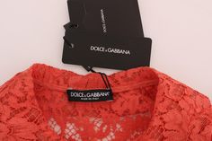 Dolce & Gabbana Gorgeous brand new with tags, 100% Authentic DOLCE & GABBANA floral lace crystal cardigan blouse. Model: Short sleeve cardigan blouse Collection: SICILY Color: Orange peach Pink crystal floral buttons Logo details Made in Italy Material: 33% Cotton, 37% PA, 30% Viscose Luxury Long Sleeve Tops With Lace Trim, Floral Lace Blouse, Orange Crystals, Crystal Buttons, Dolce E Gabbana, Short Sleeve Cardigan, Peach Pink, Dolce & Gabbana, Pink Crystal