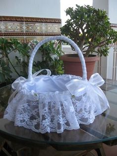 a white basket sitting on top of a glass table