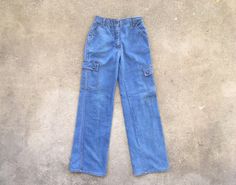 --  Vintage 1970s K Mart Cargo Pocket Light Blue Flare / Wide Leg Jeans --  Very good condition with general light wear, but look very nice overall!  --  Super cool design and ideal for designers and purveyors of good style --  Size 27 x 31 1/2, but please see below for measurements --  Thanks for looking and have a fantastic day! MEASUREMENTS Waist - 13 1/2 inches across; 27 inch waist Hips - 17 1/2 inches across; 35 inch hips Rise - 11 1/8 inches Inseam - 31 1/2 inches Total Length - 42 inches Vintage Medium Wash Cargo Jeans For Spring, Retro Medium Wash Cargo Jeans, Vintage Wide Leg Medium Wash Cargo Jeans, Vintage Full-length Cargo Jeans, K Mart, Pocket Light, Cargo Pocket, Vintage 1970s, Super Cool