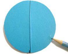 a blue paper ball with a pencil sticking out of the middle and one piece missing