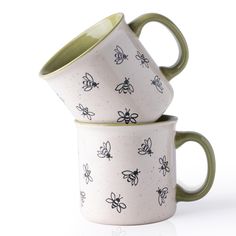 two green and white mugs with bees on them