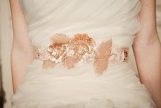 "JENNY SASH- ROSE GOLD DESCRIPTION Rose Gold Beaded Floral & Vine Organic Shaped Applique with Blush Fabric Rosettes by Camilla Christine Bridal Accessories and Wedding Jewelry *10 3/4\" Long by 41/2\" Wide (at Widest Point) Applique *Rose Gold Sequins & Bugle Beads w/ Blush Colored Georgette Flowers *1 1/2\" wide by 90\" Long Gold Satin Sash IMPORTATNT INFO *Ships in 1-10 Business Days *       Available for a guaranteed 1-2 business day ship window by purchasing the \"Rush Order Fee\" Add-on he Beaded Bridal Sash, Fabric Rosette, Gold Inspiration, Flower Belt, Wedding Belt, 2016 Wedding, Wedding Sash Belt, Organza Flowers, Rose Gold Sequin