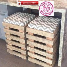 some wooden crates stacked on top of each other in front of a kitchen countertop