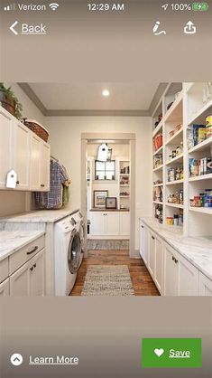 an image of a laundry room with white cabinets and washer in the center, next to a door