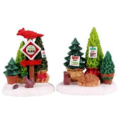 two small christmas trees with signs on them