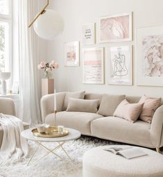 a living room filled with furniture and pictures on the wall above it's coffee table