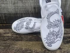 * PLEASE READ CAREFULLY BEFORE PLACING ORDERS*       *Labor ONLY - you will shipped your own shoes to me, message me for my address       *GREAT ART TAKES TIME  it will takes 3 to 4 weeks to finish a pair       * WANT IT ASAP? add the rush order link in your cart, and it WILL MOVE YOUR ORDER TO                         THE TOP OF THE DESIGN SCHEDULE.              https://www.etsy.com/listing/499308347/rush-order?ref=shop_home_active_5 These shoes are made to order, so when purchasing the listing please send me a message if you want some revision to the design, I can also personalize it by adding  your name. Since I do paint them by hand, they can take a while to complete. *Each pair is hand painted by me and they are completely unique, no two are the same. *All shoes are sealed and protecte Luxury White Slip-on Custom Sneakers, Ice And Fire Dragon, Custom Vans Slip On, Custom Slip On Vans, Black And White Dragon, Dragon Custom, Champion Sneakers, Asian Dragon, Skater Shoes