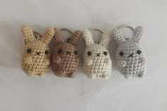 four crocheted keychains with small animals on them