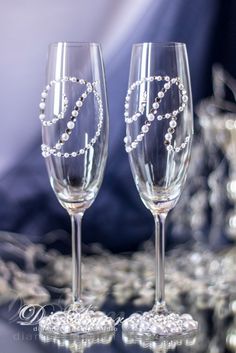 two wine glasses with beaded decorations on them