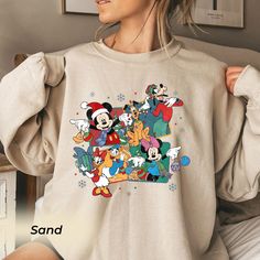 a woman wearing a sweatshirt with cartoon characters printed on the front, and an image of mickey mouse