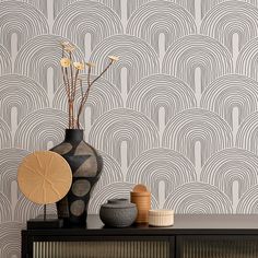 an art deco styled wallpaper with wavy lines in grey and white, on a black cabinet