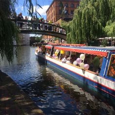 a boat filled with people riding down a river