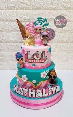 a birthday cake with lol dolls on top